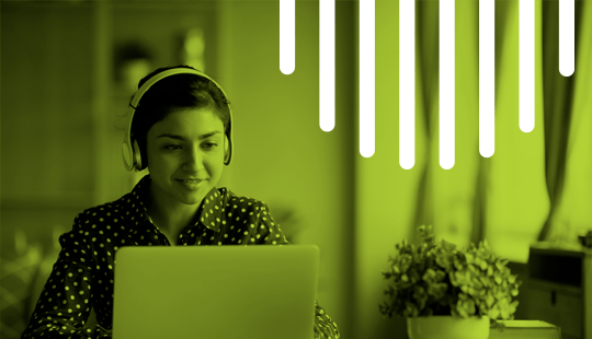 Person wearing headphones sits at a desk with a laptop, background has a potted plant and vertical light stripes. Image is tinted green.
