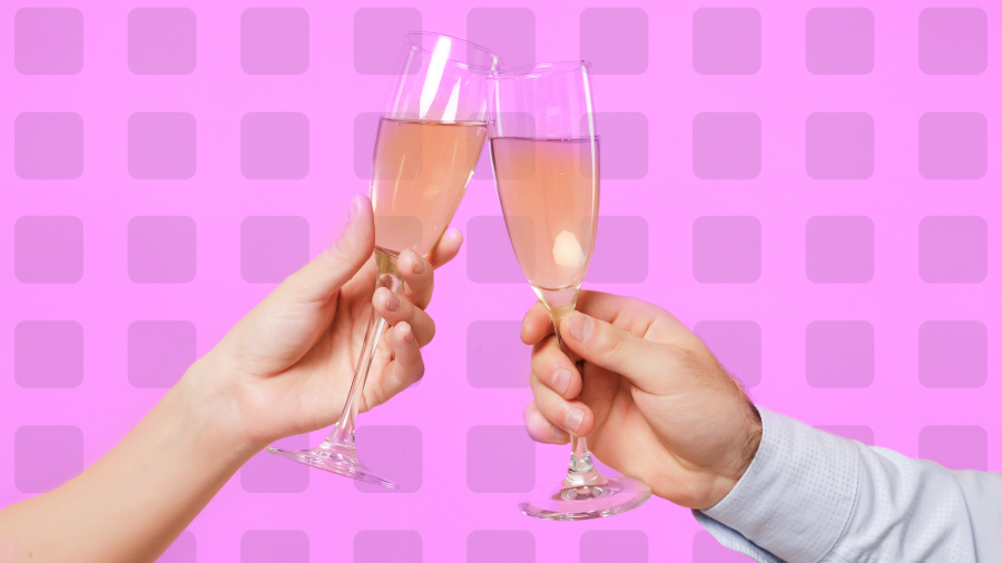 Two hands clinking champagne glasses filled with a pinkish beverage against a pink background with a square pattern, making the perfect toast for a chic corporate event planning celebration.